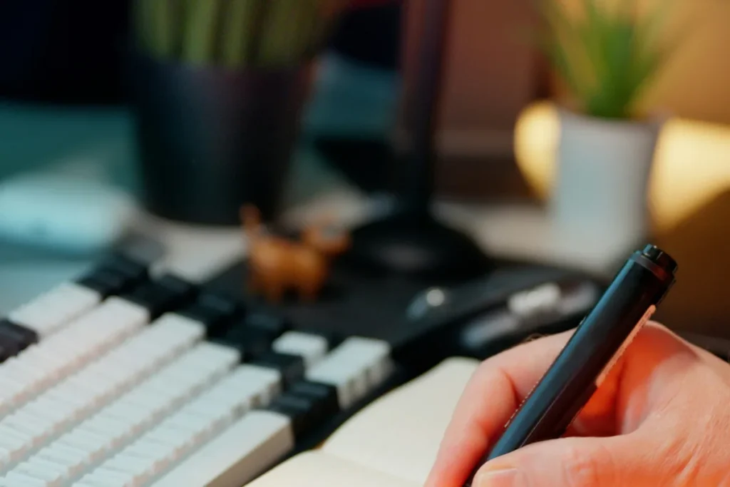 Handwritten checklist in a notepad on a desk, listing free SEO jobs to do before paying anyone