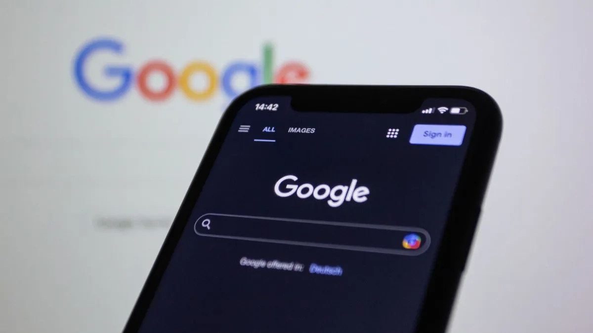 Small business website design 1 Someone searching Google on a phone, the way most customers look for a local small business